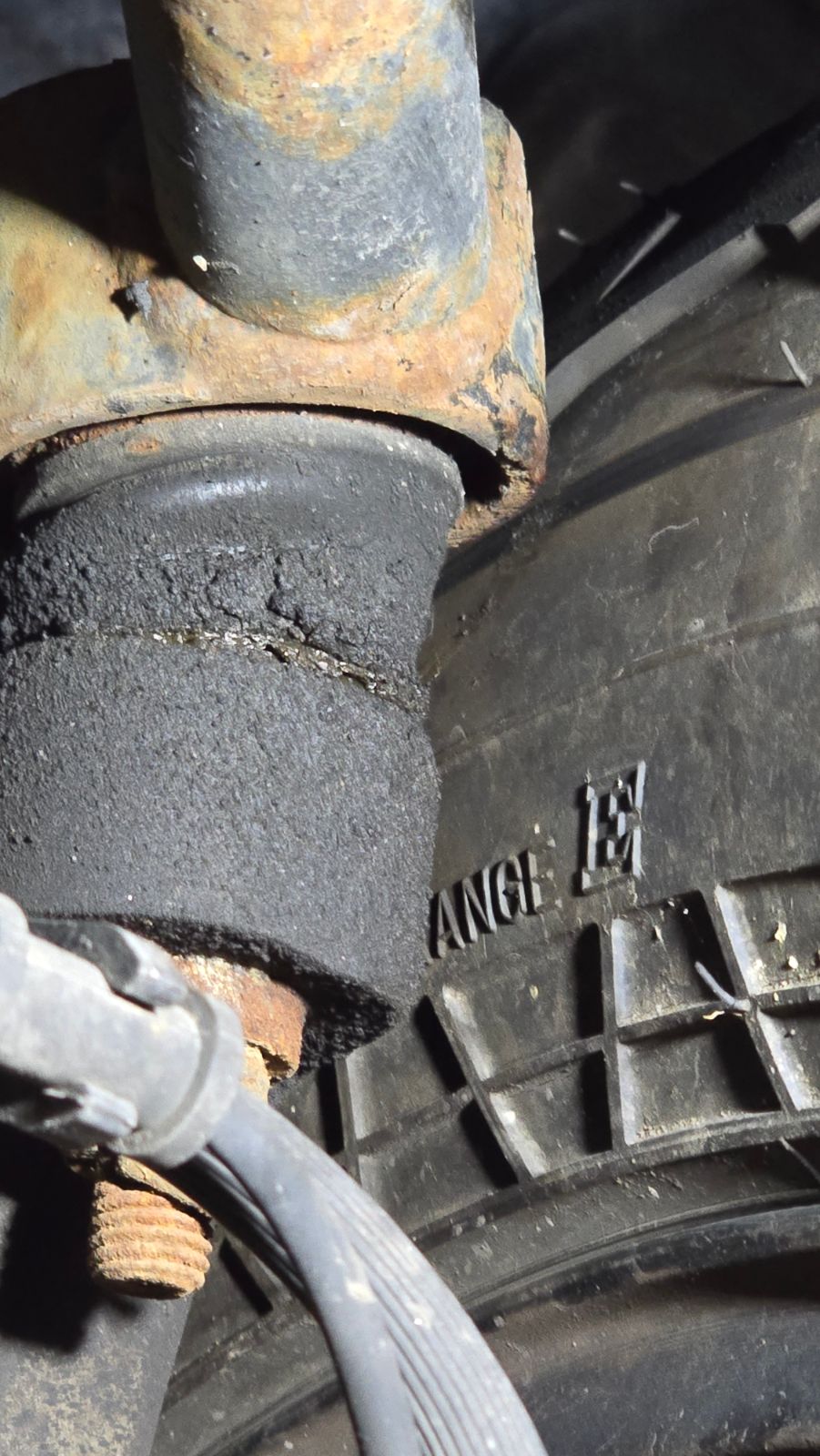 Closer look at the right front upper control arm rubbing on the wheel