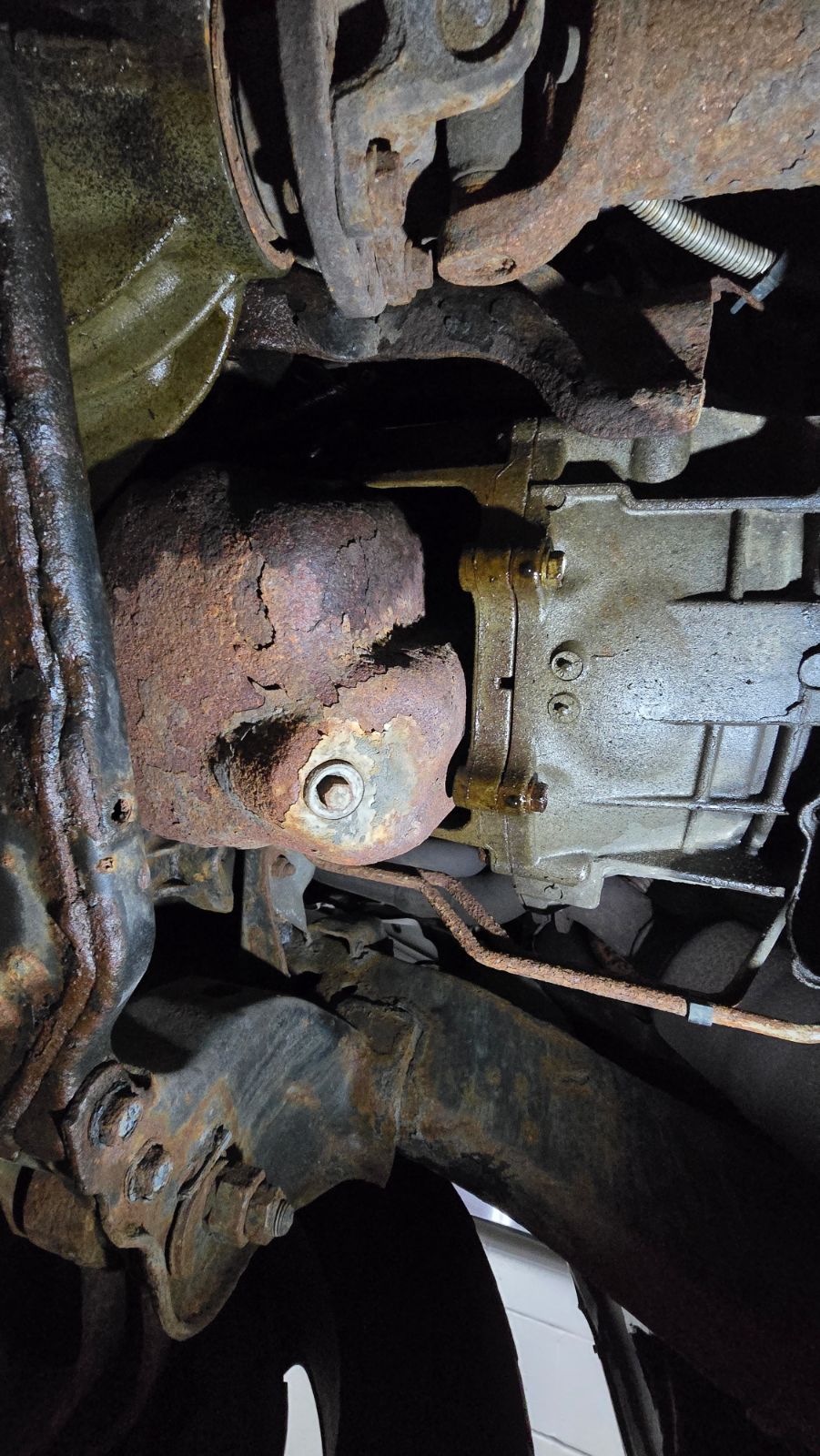 Minor engine oil leak, possibly from the rear main seal, not enough to fail the safety