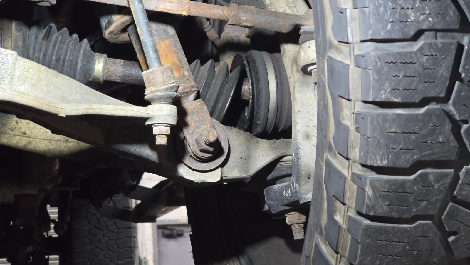 Front CV axle boot ripped open and leaking grease
