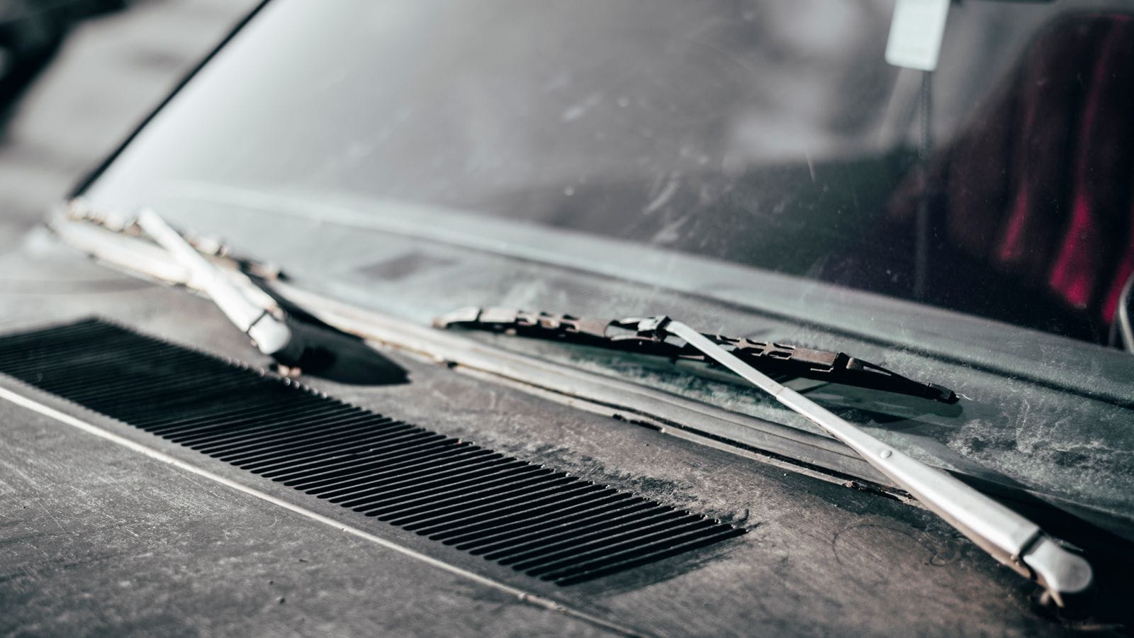 A wiper blade resting on a car windshield